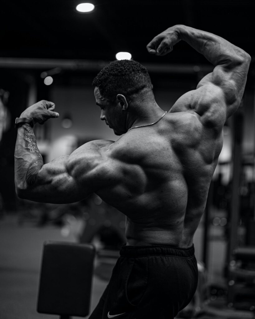 A Muscular Man Flexing His Muscles at the Gym 